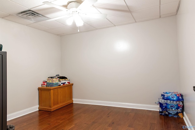 unfurnished room with ceiling fan, dark hardwood / wood-style flooring, and a paneled ceiling