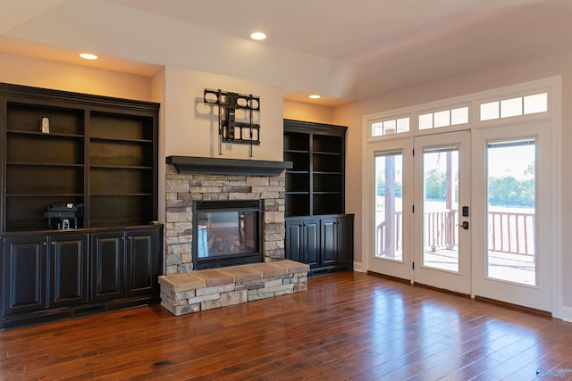 living room featuring dark hardwood / wood-style flooring, a fireplace, and french doors