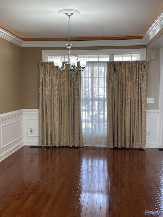 spare room with crown molding, hardwood / wood-style flooring, and plenty of natural light