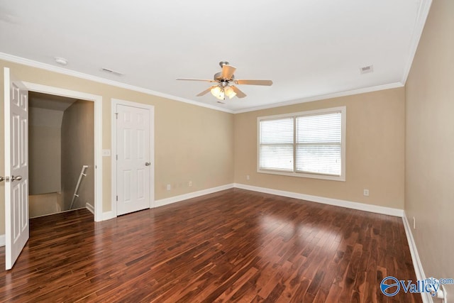 unfurnished room with visible vents, crown molding, ceiling fan, baseboards, and dark wood-style flooring