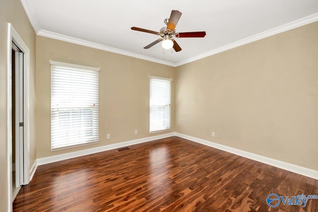 unfurnished room with baseboards, visible vents, ceiling fan, ornamental molding, and dark wood-type flooring