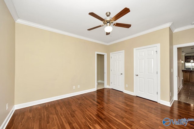 unfurnished bedroom featuring ceiling fan, crown molding, baseboards, and wood finished floors