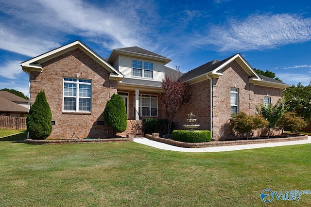 view of front of home with brick siding, crawl space, a front yard, and fence