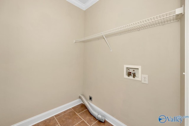 washroom with dark tile patterned flooring, baseboards, hookup for an electric dryer, hookup for a washing machine, and laundry area