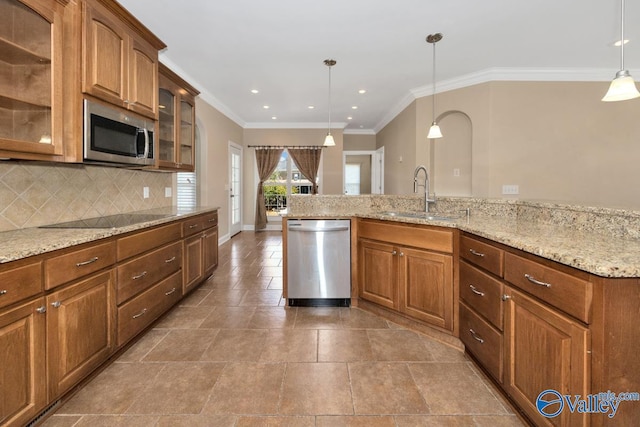 kitchen with a sink, brown cabinetry, backsplash, and stainless steel appliances