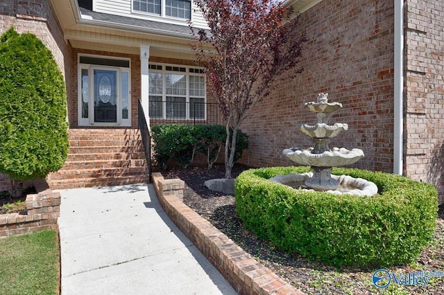 entrance to property featuring brick siding