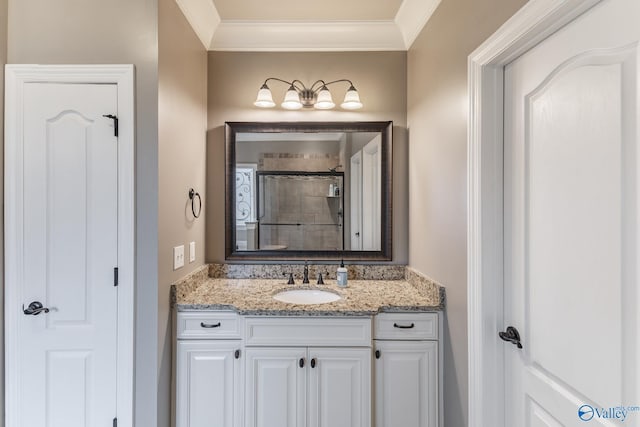 full bathroom with crown molding, tiled shower, and vanity