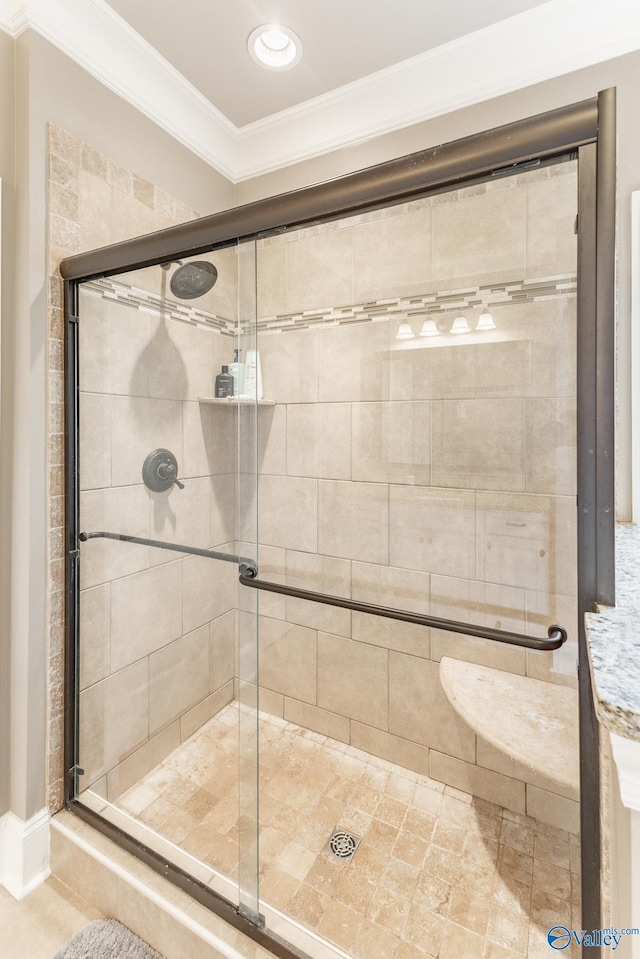 bathroom with a shower stall and ornamental molding