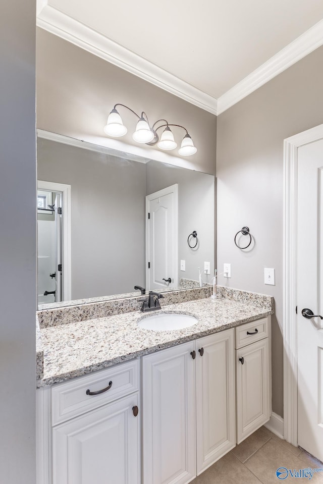 bathroom with tile patterned floors, vanity, and ornamental molding