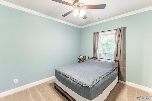 bedroom featuring crown molding, visible vents, baseboards, and light carpet