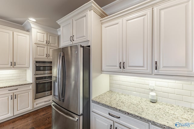 kitchen featuring dark wood-style flooring, white cabinetry, crown molding, decorative backsplash, and stainless steel appliances