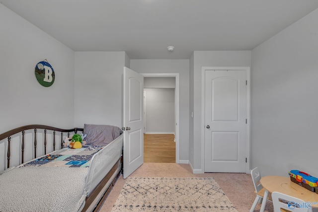 bedroom featuring light carpet