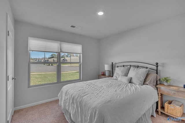 bedroom with light colored carpet