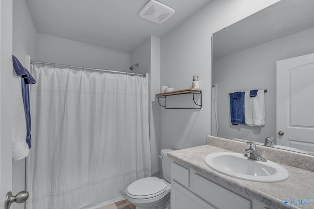 bathroom with vanity, a shower with shower curtain, and toilet