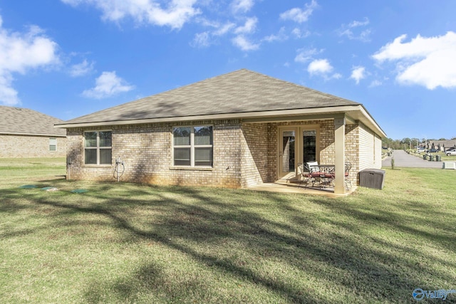 back of property featuring a lawn and a patio area