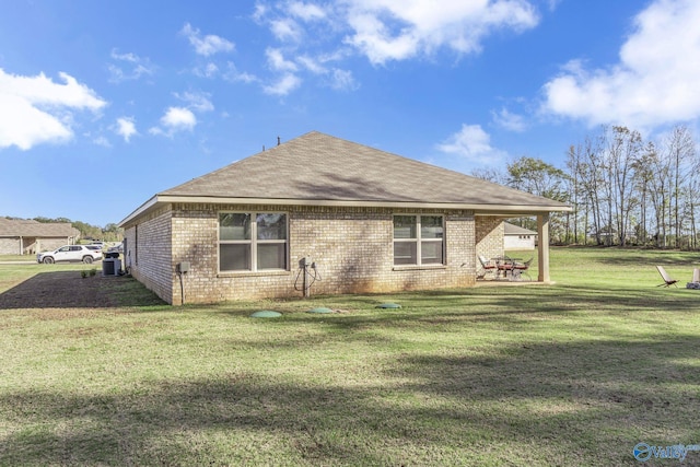 rear view of house with a patio area and a yard