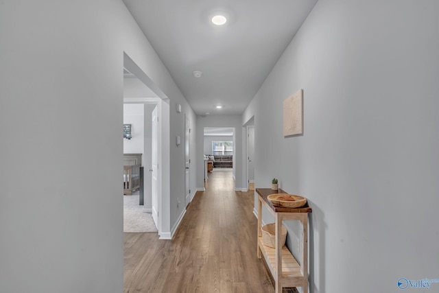 corridor with light wood-type flooring