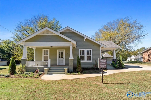 craftsman-style home with a front yard and a porch