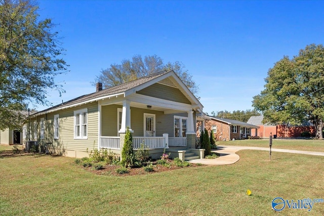 view of front of home with central AC, a front yard, and a porch