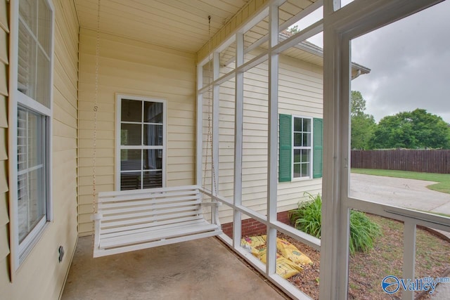 doorway to property featuring fence