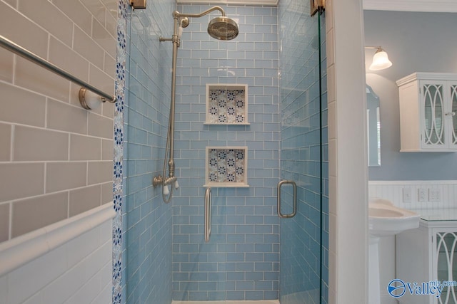 full bathroom with a wainscoted wall and a stall shower
