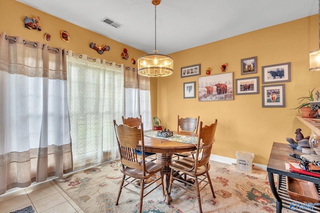 dining space featuring a notable chandelier and light tile patterned floors