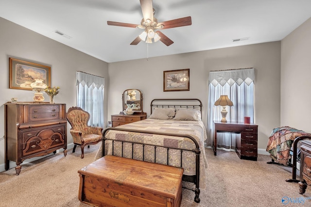 carpeted bedroom with ceiling fan and multiple windows