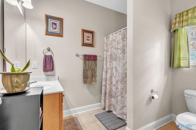 bathroom with vanity, toilet, and tile patterned flooring