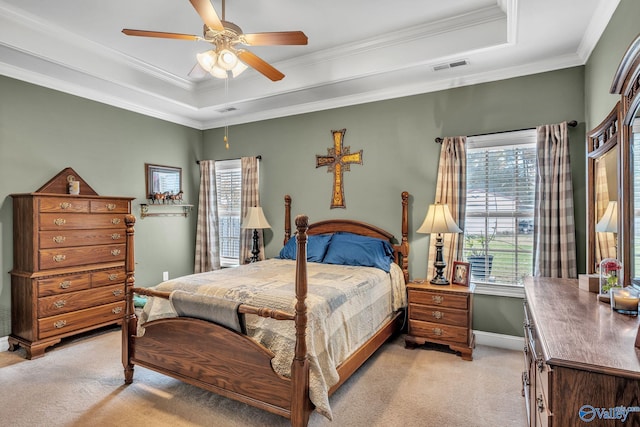 carpeted bedroom featuring ceiling fan, a raised ceiling, and ornamental molding