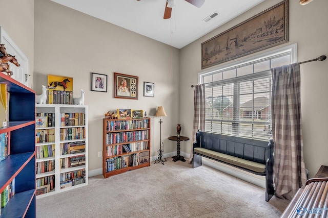 interior space with carpet and ceiling fan