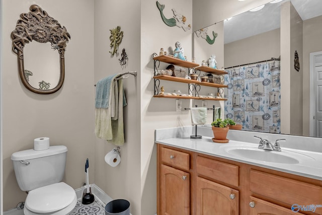 bathroom featuring vanity, toilet, and tile patterned flooring