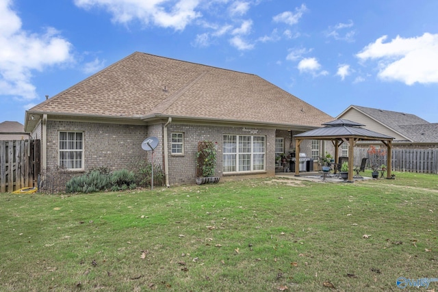 back of house featuring a gazebo, a yard, and a patio