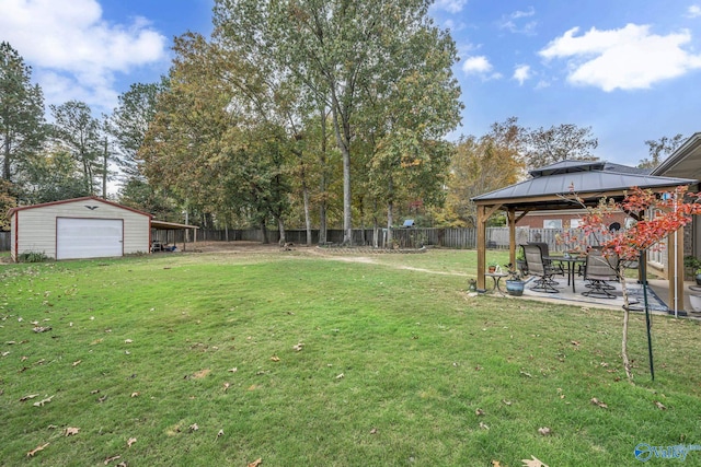 view of yard featuring a gazebo, an outdoor structure, and a patio