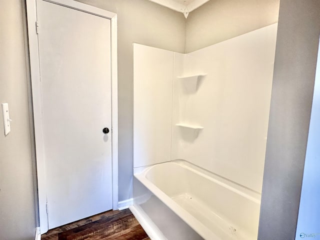 bathroom featuring hardwood / wood-style flooring and tub / shower combination