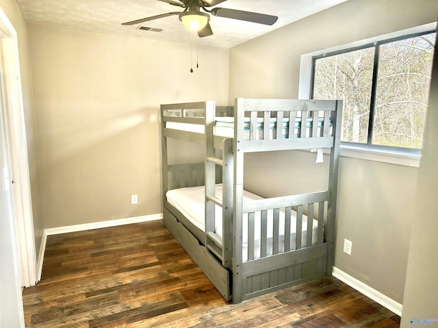 bedroom featuring dark hardwood / wood-style flooring and ceiling fan