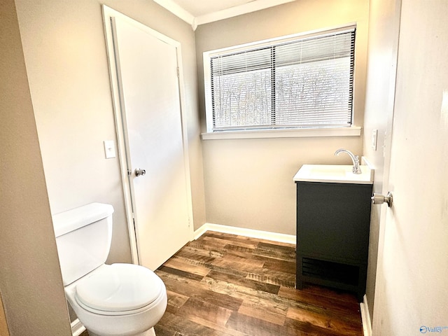 bathroom featuring hardwood / wood-style floors, vanity, toilet, and ornamental molding