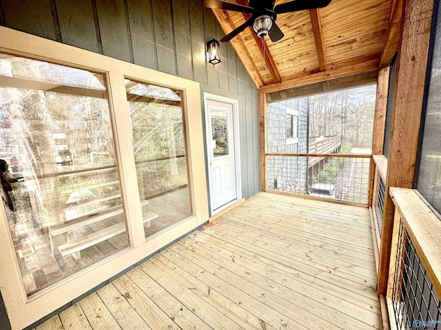 unfurnished sunroom with vaulted ceiling with beams, ceiling fan, and wood ceiling