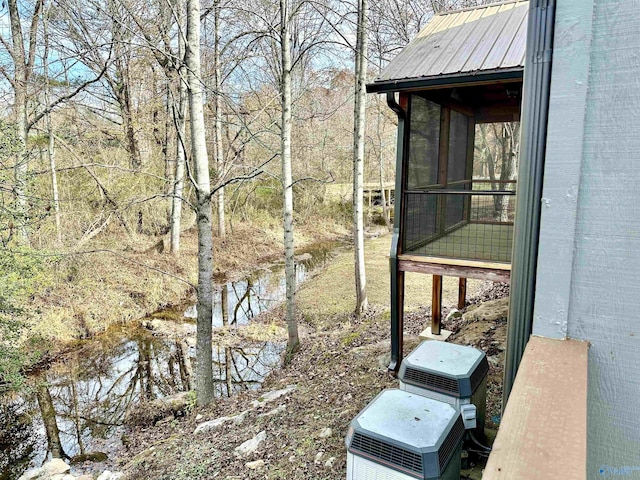 exterior space featuring a water view and a sunroom