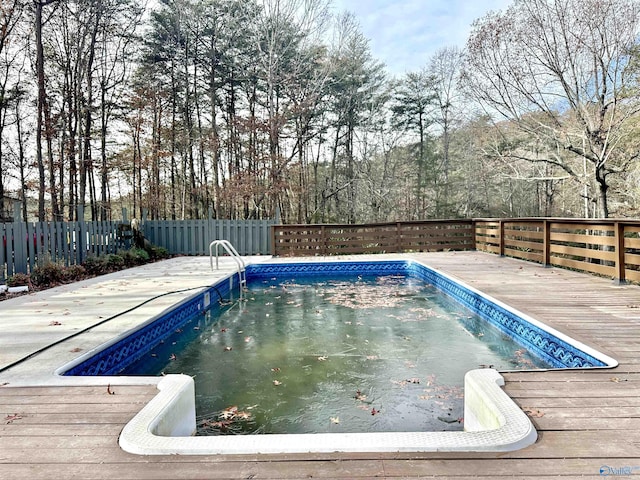 view of swimming pool featuring a wooden deck