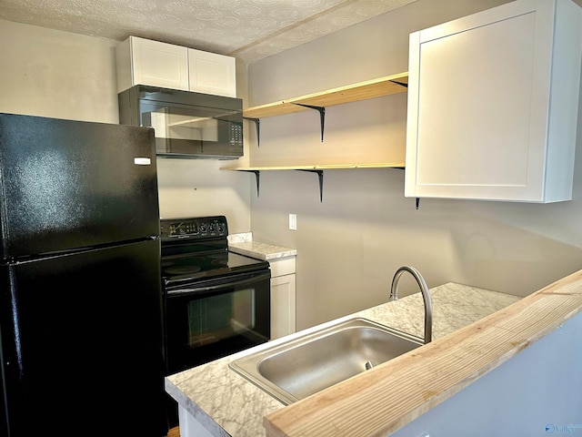 kitchen with a textured ceiling, sink, white cabinetry, and black appliances