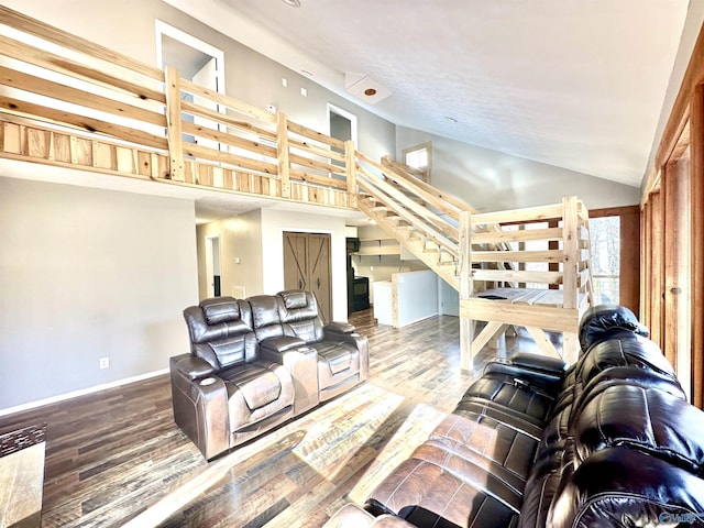 living room with hardwood / wood-style flooring and high vaulted ceiling