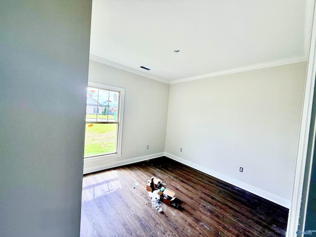 1005 Newbury Cv SW, Decatur, AL 35603 - spare room featuring crown molding, baseboards, and dark wood-style flooring