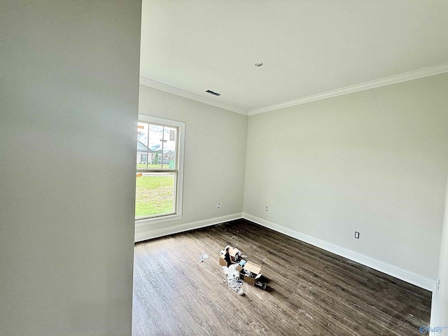 1005 Newbury Cv SW, Decatur, AL 35603 - unfurnished room with crown molding, baseboards, and dark wood-style floors