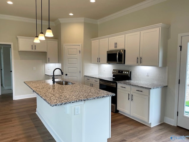 kitchen featuring white cabinetry, an island with sink, sink, light stone counters, and stainless steel appliances