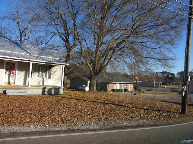 view of front of house featuring covered porch and metal roof