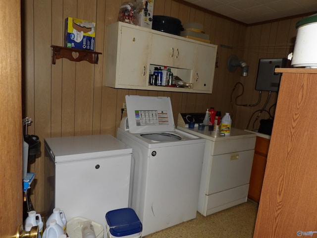 laundry area with wood walls and washing machine and dryer