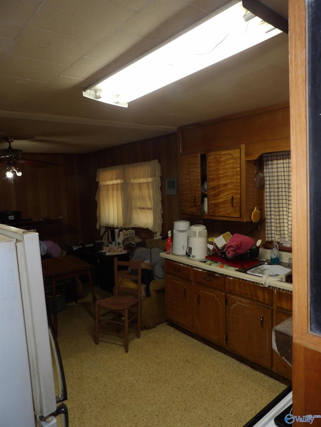 kitchen with wooden walls and white fridge