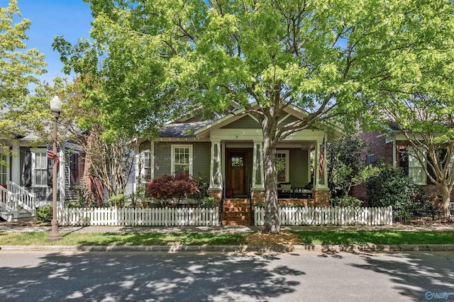 9 Beck St NW, Huntsville, AL 35806 - bungalow-style home featuring brick siding, a fenced front yard, and covered porch