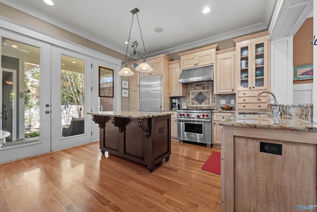9 Beck St NW, Huntsville, AL 35806 - kitchen featuring crown molding, under cabinet range hood, premium appliances, and a sink