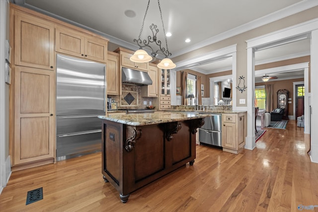 9 Beck St NW, Huntsville, AL 35806 - kitchen featuring light brown cabinets, light wood finished floors, stainless steel built in fridge, a kitchen bar, and under cabinet range hood